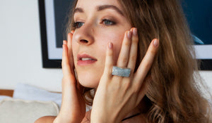 blond woman putting a facial oil serum with her fingers